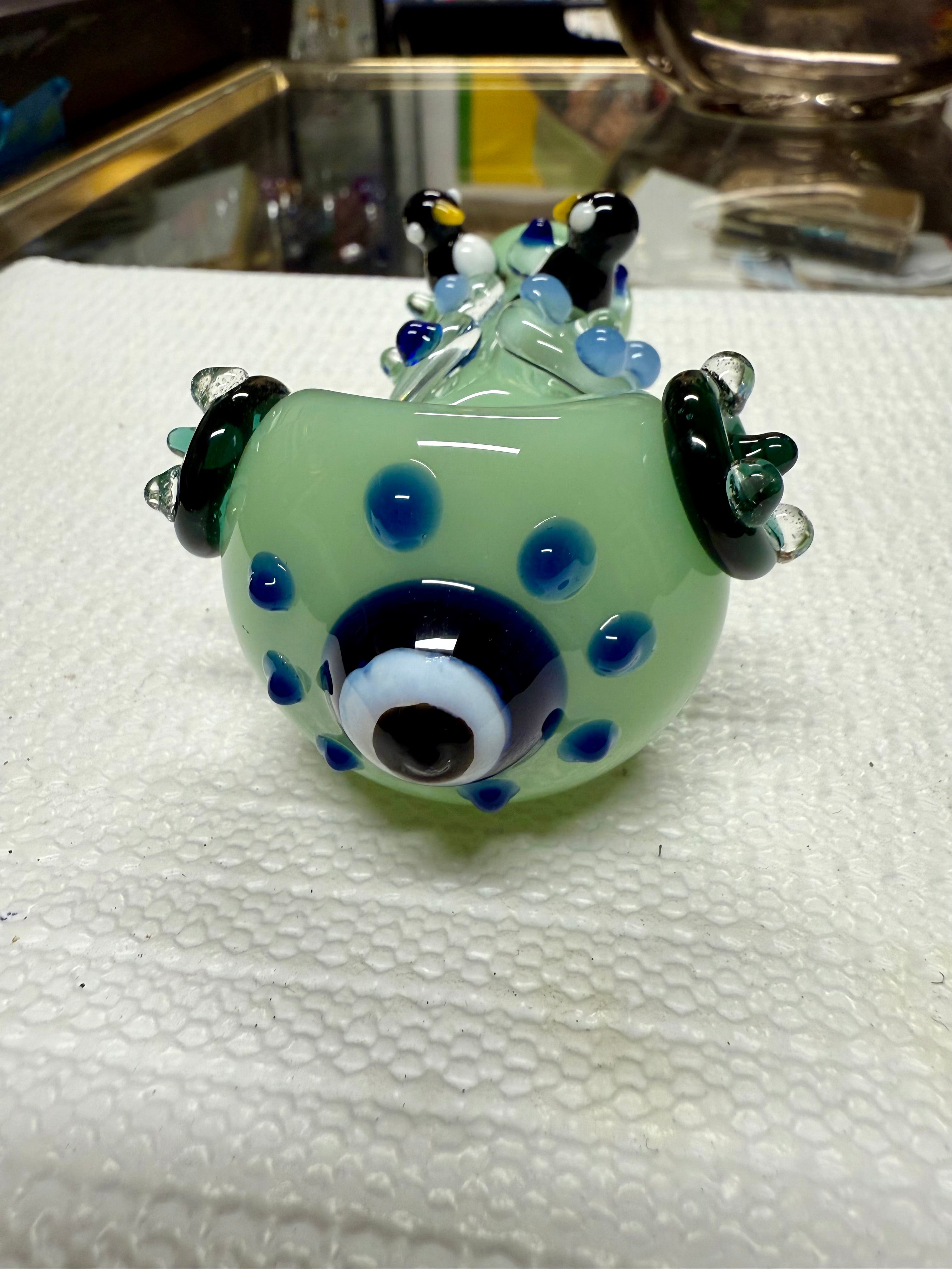 Ripkitty 4.5" penguin art pipe — mint green colorway, angled view showing penguin trio sculpts and blue polka dot body