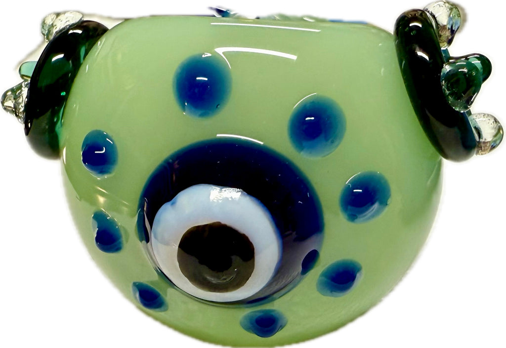 Ripkitty 4.5" penguin art spoon pipe — mint green colorway, front bowl view showing large evil eye accent, blue dot pattern, and dark green flipper accents, white background