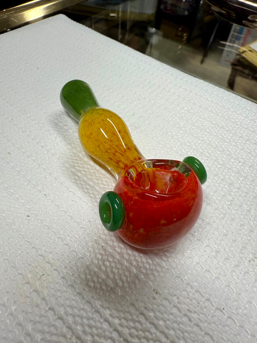 Ripkitty 3.5" Rasta art spoon pipe — handblown glass in red, yellow, and green rasta colorway with green marble accents, displayed on white surface