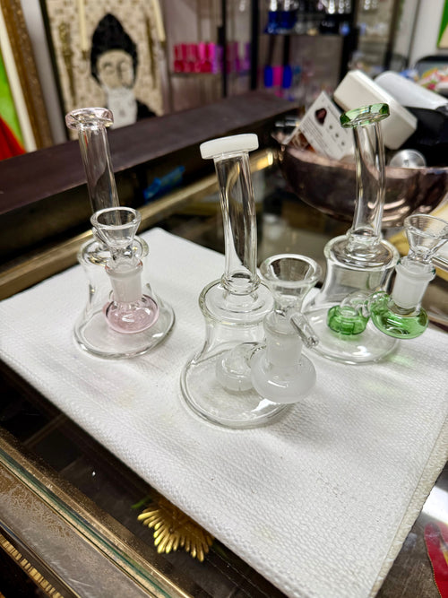 Ripkitty 7" conical bong with color shower percolator — iridescent fumed neck with twisted color pull, green base accent, 14mm male funnel bowl inserted, white background