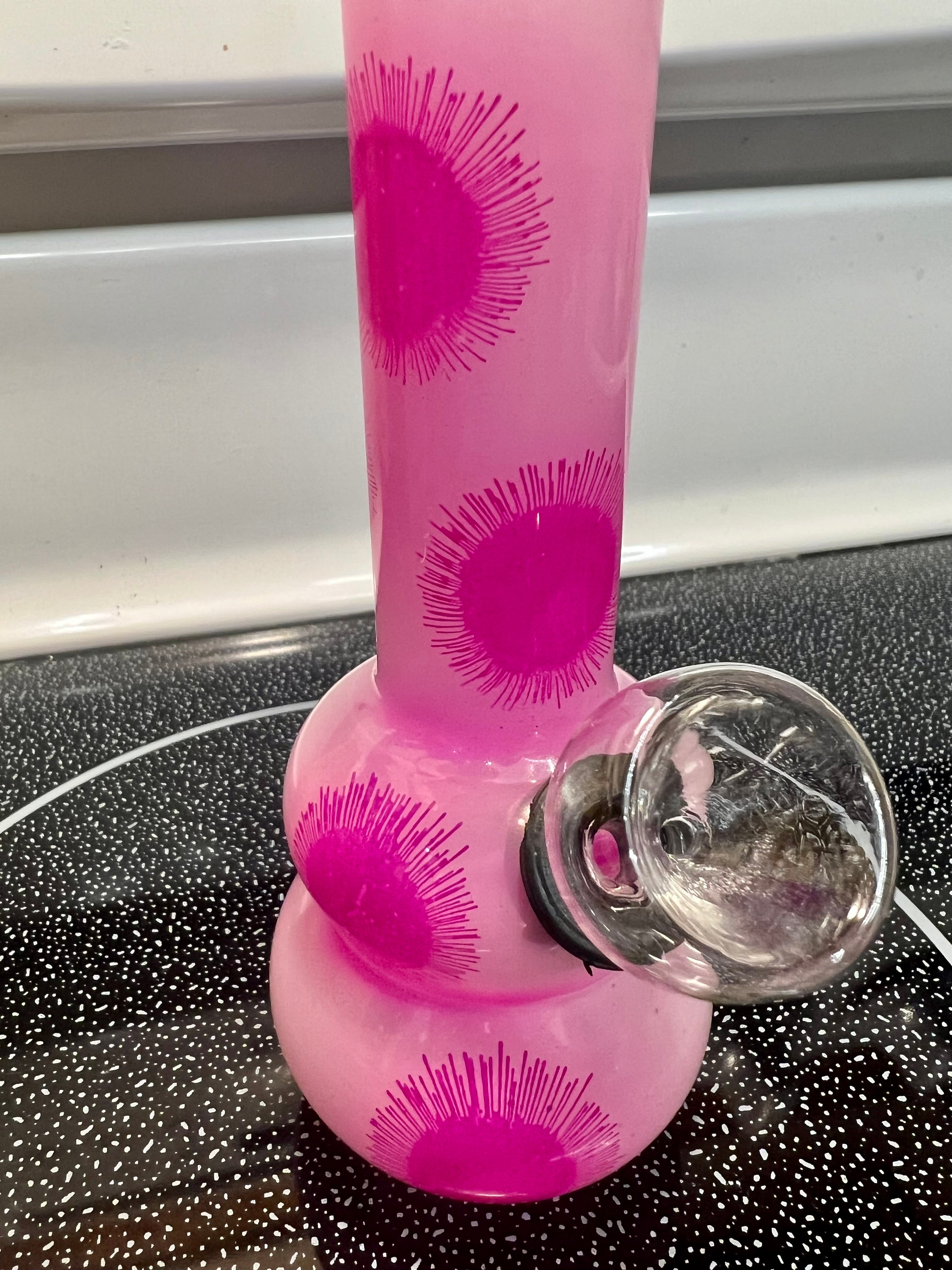 Ripkitty 5-inch soft glass water pipe, pink frosted finish with hot pink starburst print pattern, bowl piece inserted, side angle view