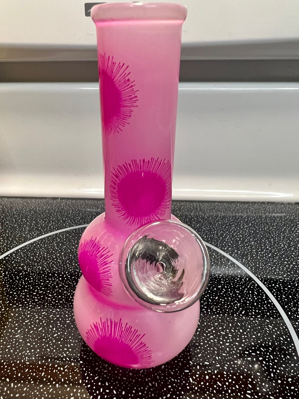 Ripkitty 5-inch soft glass water pipe, pink with starburst print, double-bubble base detail, bowl piece visible, front angle view